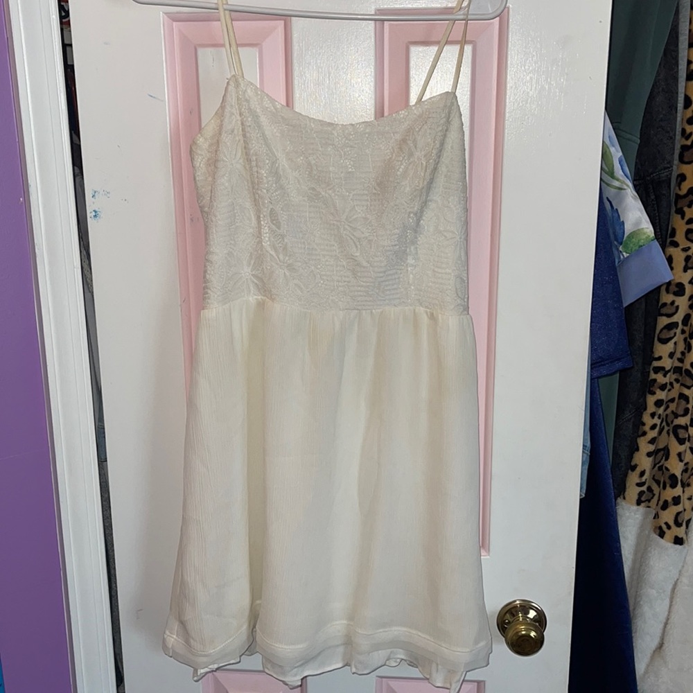 White dress with a floral lace detail on the top!